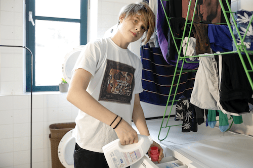 Teenage boy doing the laundry