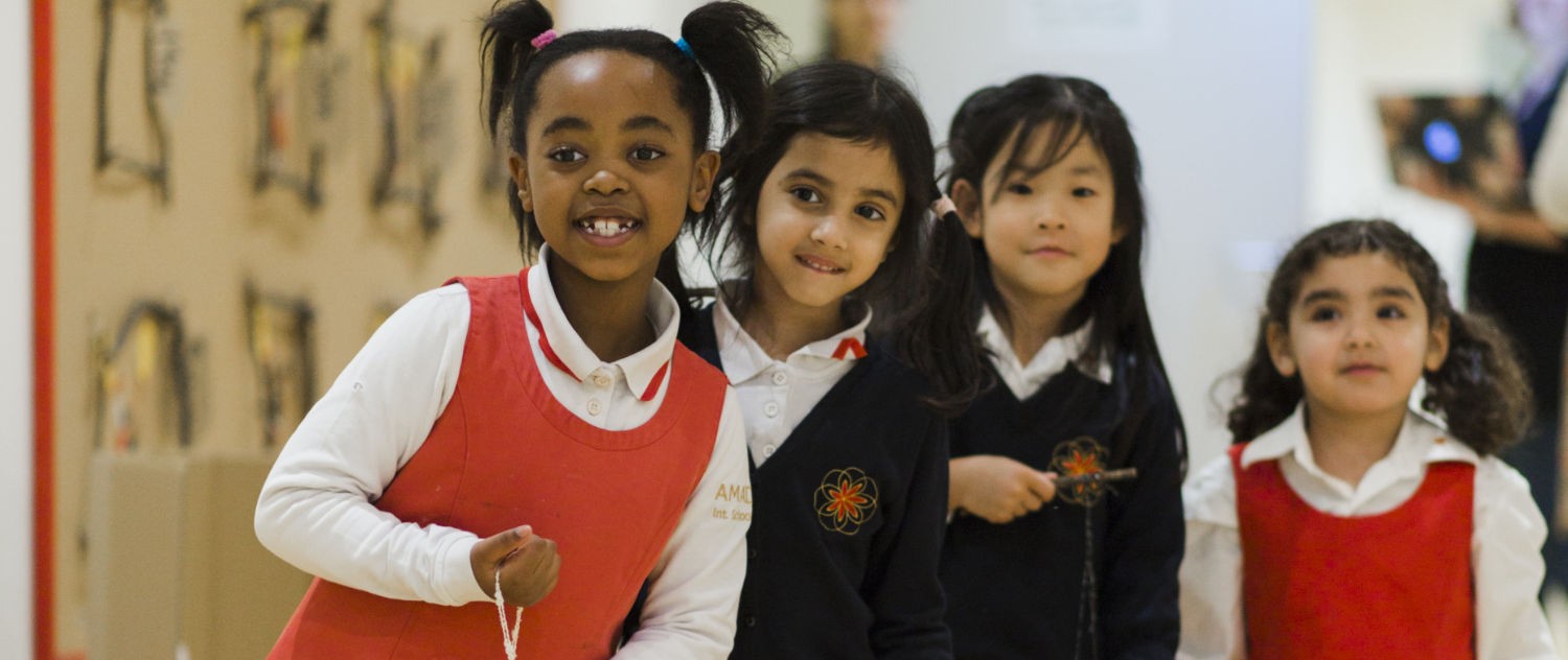 Young girls in school uniform looking happy