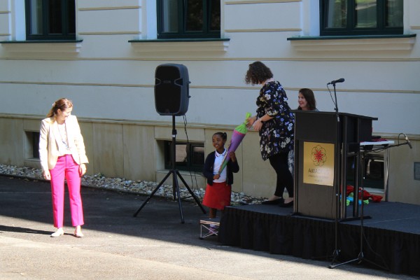 Early Years student receiving gift at AMADEUS Vienna